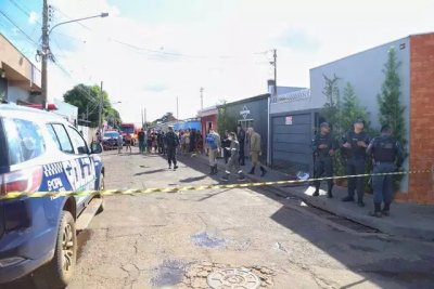 Policiais na frente da casa onde Dinho foi encontrado morto, cado perto do porto (Foto: Paulo Francis)